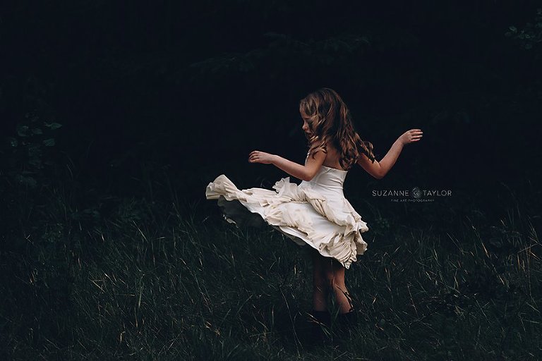 Red Deer Photographer Suzanne Taylor captures a young girl twirling in a dress in Edmonton, AB.