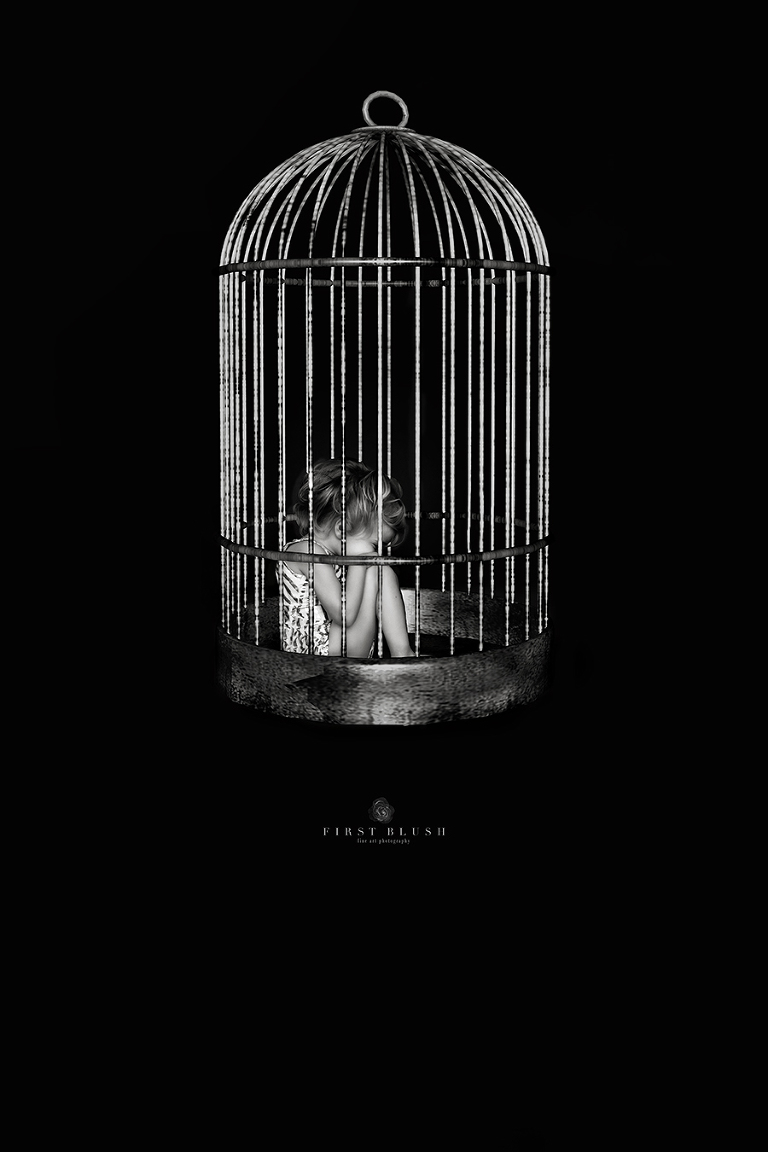 Child trafficking and a child that has been caged in an old style bird cage waiting.